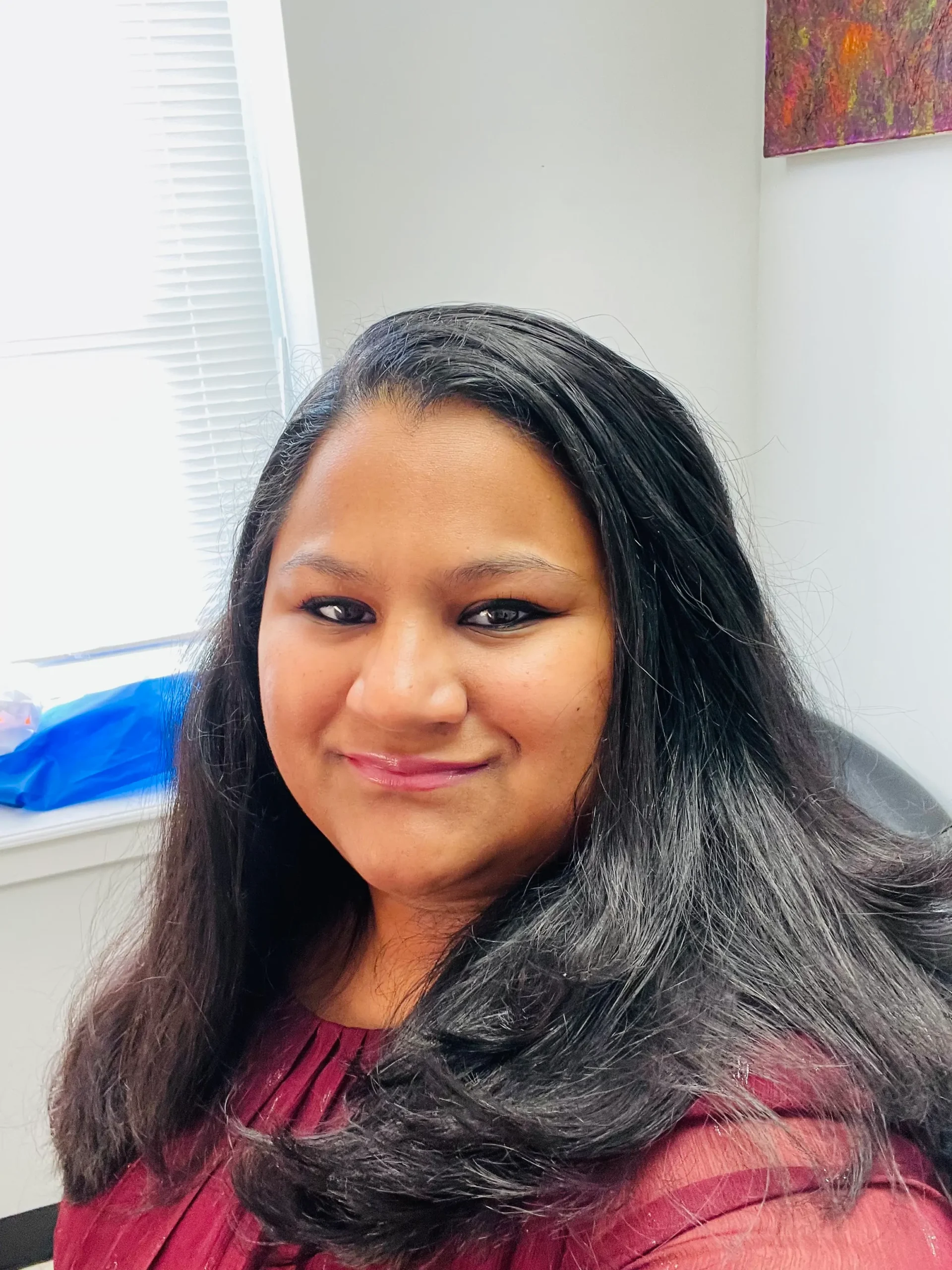 A woman with long hair sitting in a chair
